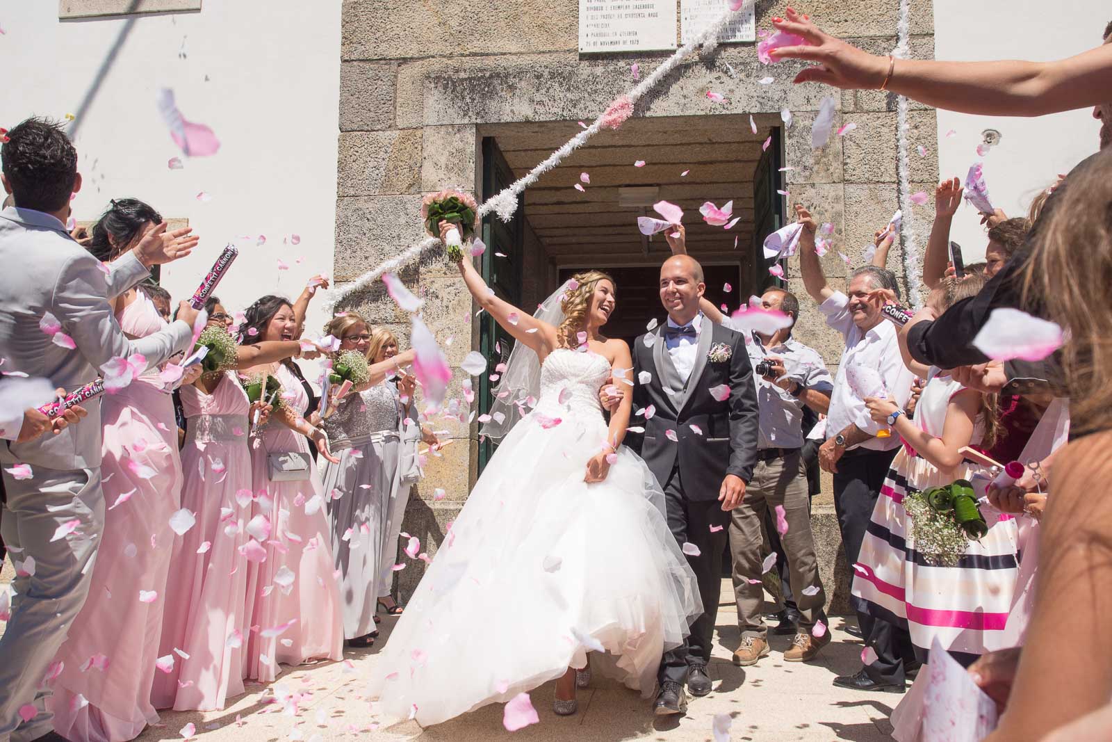 Sortie des mariés église de Queiriga Portugal. pétales de fleurs roses